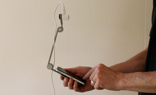 image of hand holding a smartphone with the Mr. Tappy configurable rig for capturing device usability testing